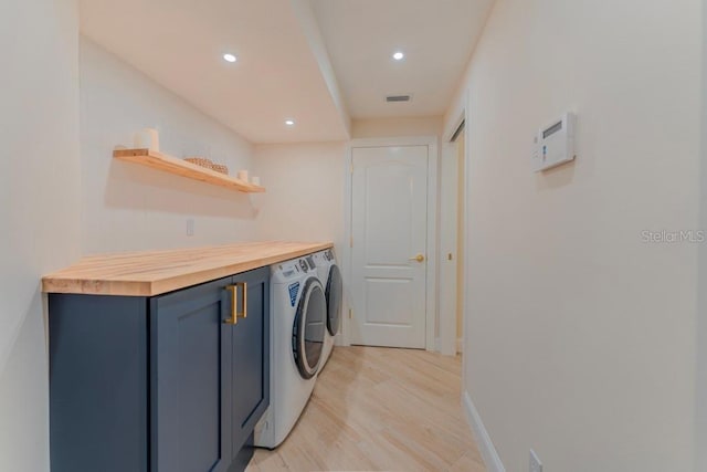 washroom featuring washer and dryer and light hardwood / wood-style flooring