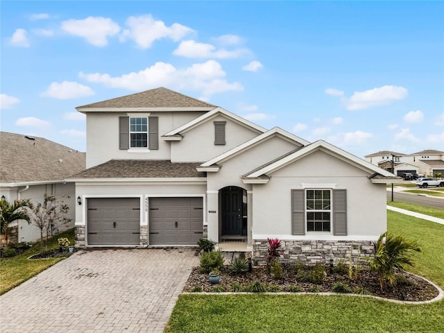 view of front property featuring a garage and a front lawn