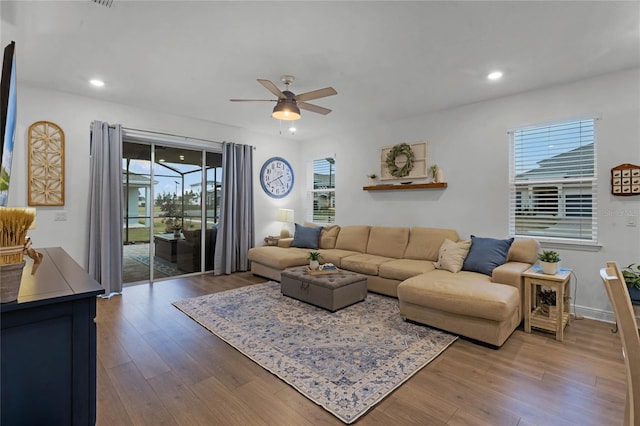 living room with hardwood / wood-style flooring, plenty of natural light, and ceiling fan