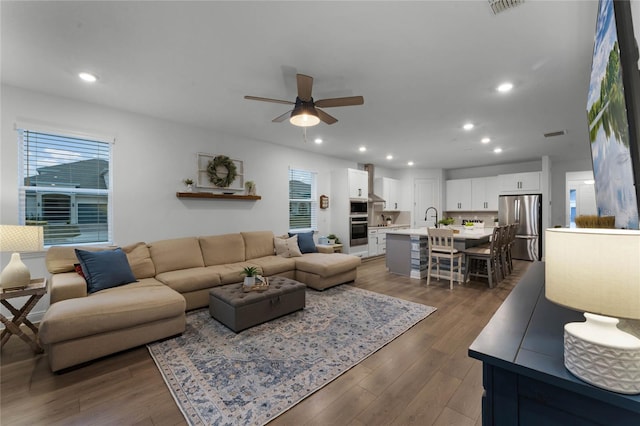 living room with sink, dark hardwood / wood-style floors, and ceiling fan