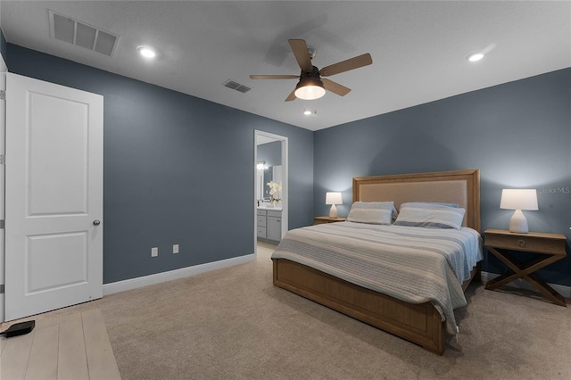 carpeted bedroom featuring ensuite bath and ceiling fan