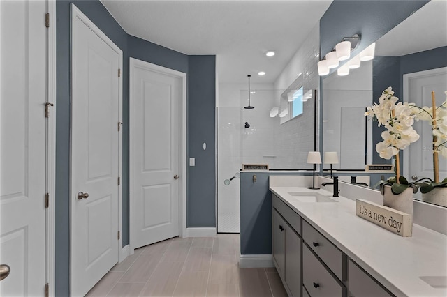 bathroom with vanity and tiled shower