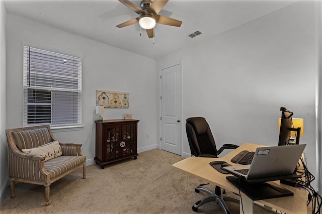 carpeted home office with ceiling fan