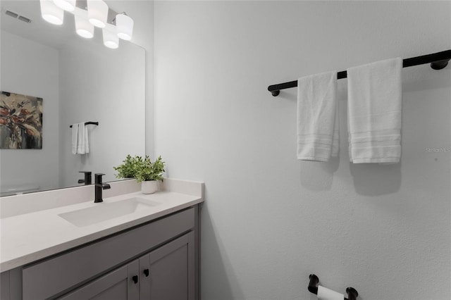 bathroom featuring vanity and a chandelier