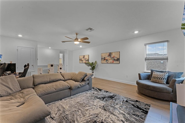 living room featuring ceiling fan and light hardwood / wood-style flooring