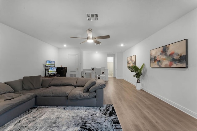 living room featuring ceiling fan and light wood-type flooring