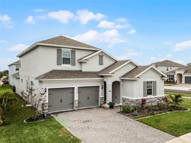 view of front of home featuring a garage and a front yard