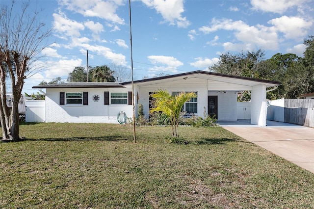 ranch-style house featuring a carport and a front lawn