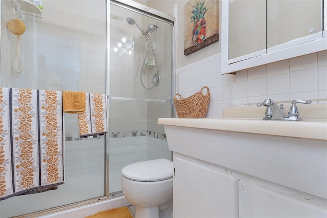 bathroom featuring tile walls, backsplash, vanity, an enclosed shower, and toilet