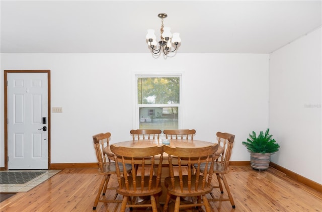 dining room featuring light hardwood / wood-style flooring and a notable chandelier