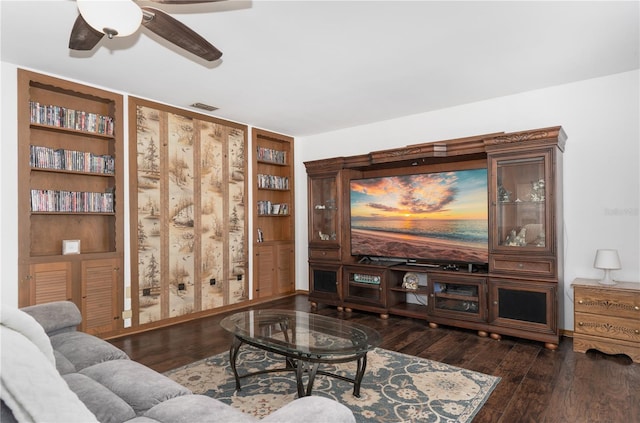 living room with dark wood-type flooring and ceiling fan