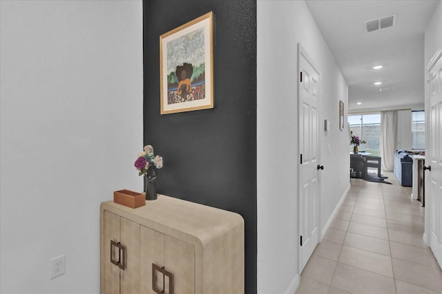 corridor featuring recessed lighting, baseboards, visible vents, and light tile patterned flooring