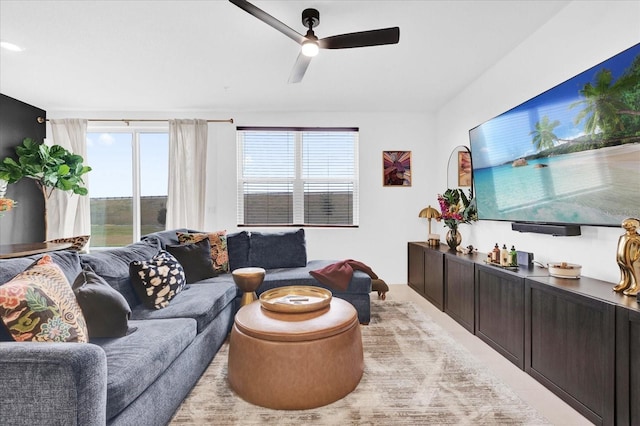 living area with a healthy amount of sunlight and ceiling fan