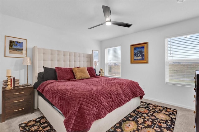 bedroom featuring baseboards, a ceiling fan, and light colored carpet