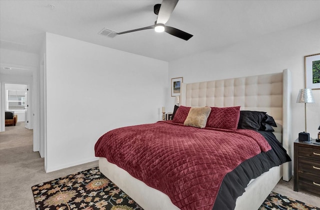 bedroom with baseboards, visible vents, a ceiling fan, and light colored carpet