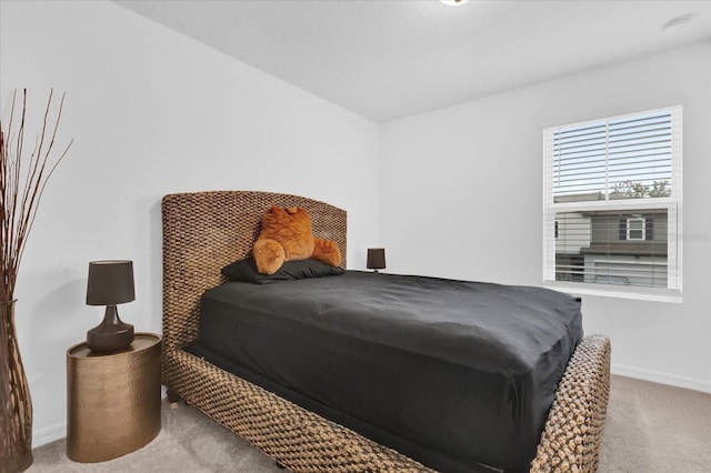 carpeted bedroom featuring baseboards