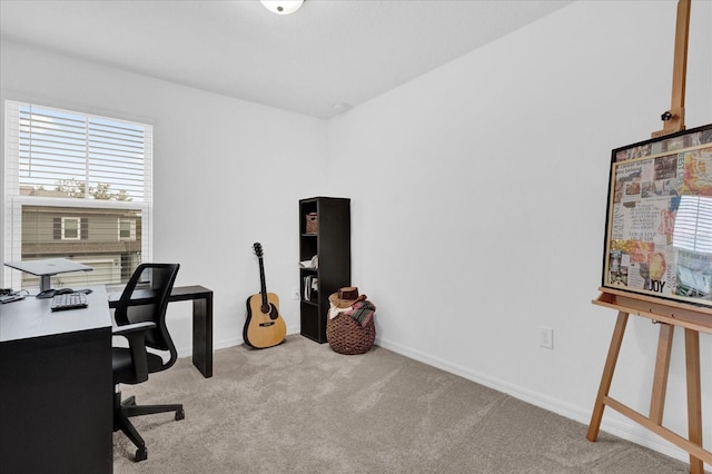 home office with light carpet and baseboards