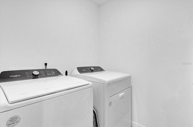 clothes washing area featuring laundry area and washing machine and clothes dryer