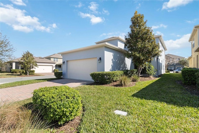 view of property exterior featuring a garage and a lawn