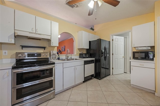 kitchen featuring sink, light tile patterned floors, white cabinetry, black appliances, and a textured ceiling