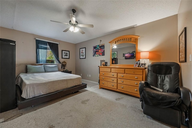 bedroom with light carpet, a textured ceiling, and ceiling fan