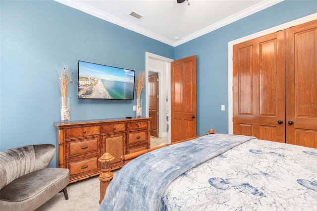 bedroom with ceiling fan, light colored carpet, visible vents, ornamental molding, and a closet