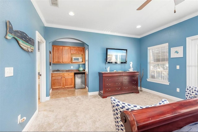 bedroom featuring light carpet, baseboards, visible vents, and crown molding