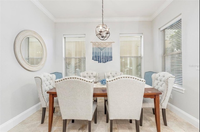 dining room with a chandelier, crown molding, and baseboards