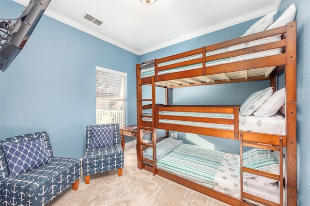 carpeted bedroom with ornamental molding and visible vents