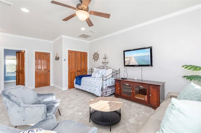 bedroom featuring baseboards, visible vents, crown molding, and light colored carpet