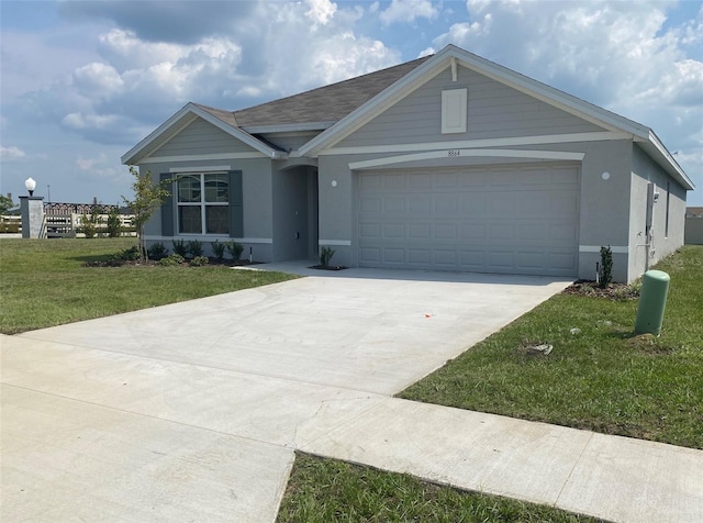 ranch-style home with a garage and a front lawn