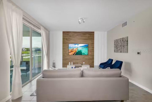 tiled living room featuring wood walls