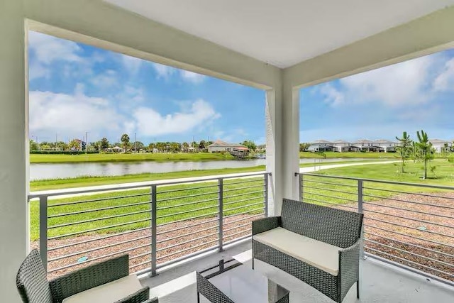 view of patio / terrace with a balcony and a water view