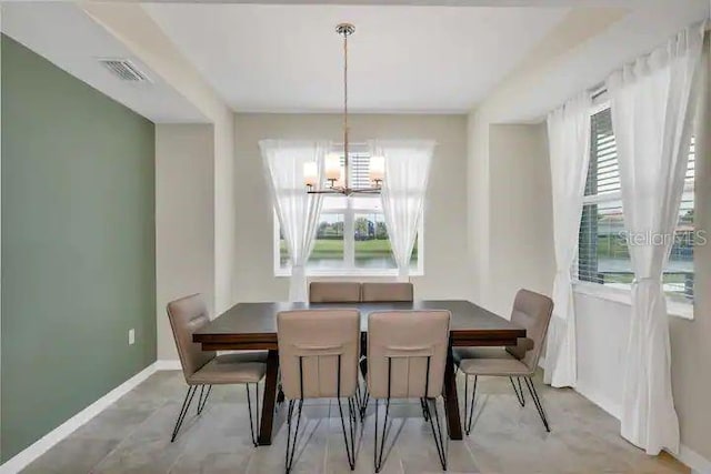 dining space with a chandelier