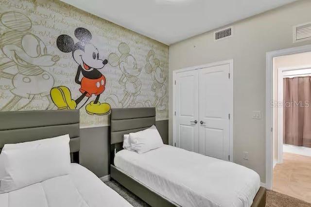 carpeted bedroom featuring a closet