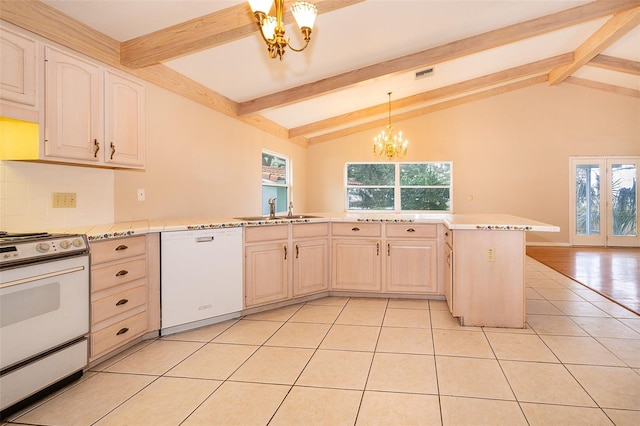 kitchen featuring dishwasher, sink, a chandelier, hanging light fixtures, and range