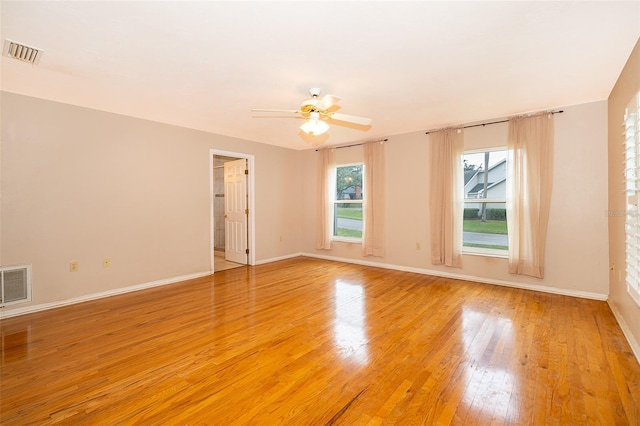 spare room with ceiling fan and light wood-type flooring