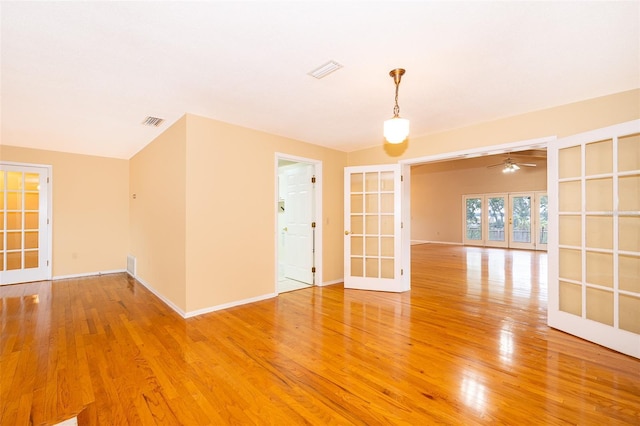 spare room with french doors, lofted ceiling, and hardwood / wood-style flooring