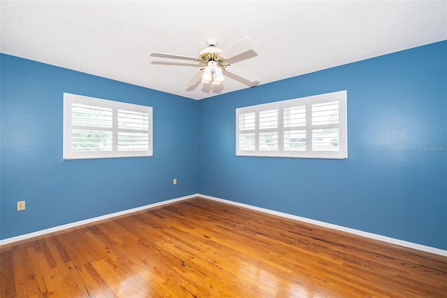 empty room featuring hardwood / wood-style floors and ceiling fan