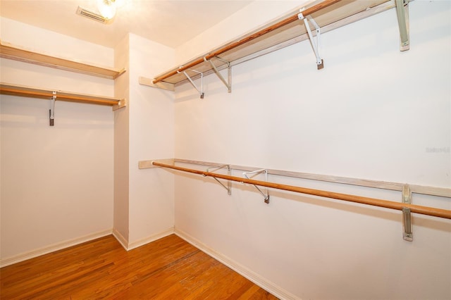 spacious closet featuring hardwood / wood-style flooring