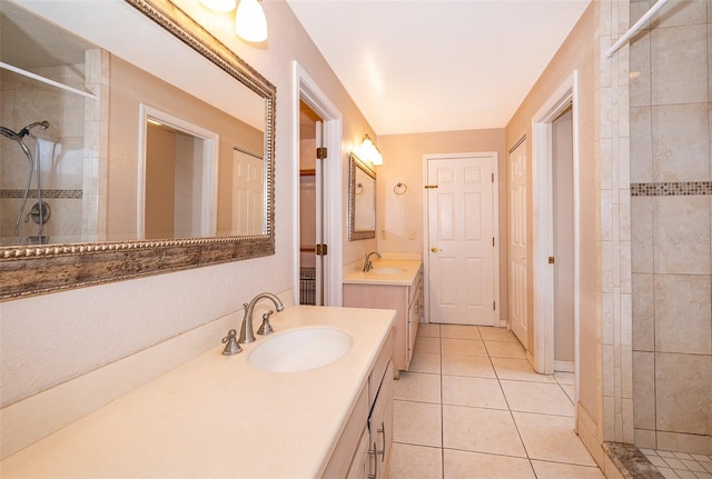 bathroom with vanity, tiled shower, and tile patterned floors