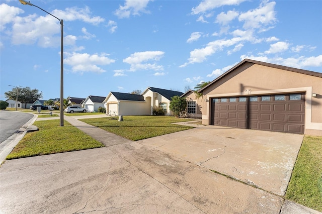 view of front facade featuring a garage and a front lawn