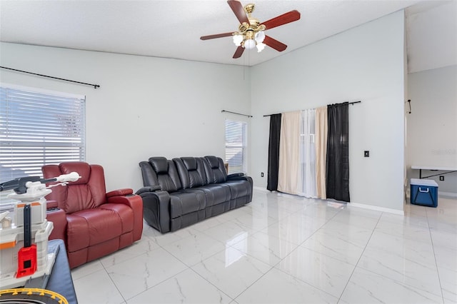 living room featuring a textured ceiling and ceiling fan