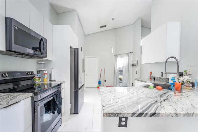 kitchen featuring sink, high vaulted ceiling, stainless steel appliances, light stone countertops, and white cabinets