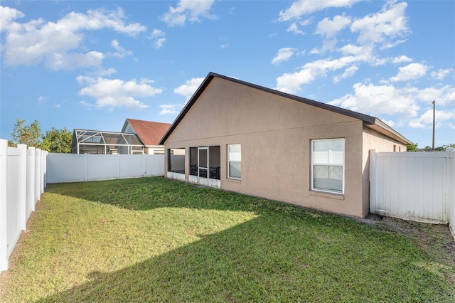 rear view of house featuring a yard