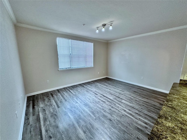 empty room with dark wood-type flooring, crown molding, a textured ceiling, and rail lighting