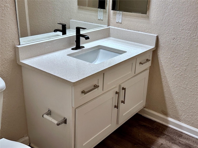 bathroom with vanity and hardwood / wood-style flooring