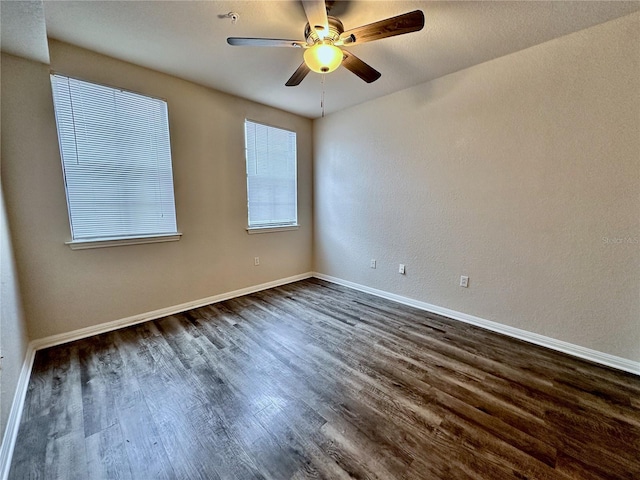 spare room featuring ceiling fan and dark hardwood / wood-style flooring