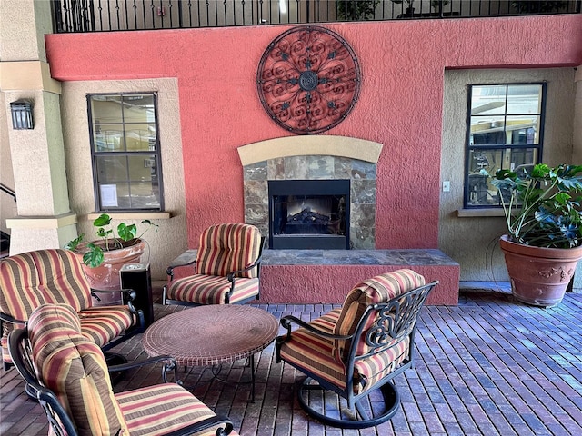 wooden terrace featuring a premium fireplace