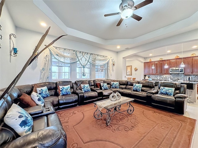 tiled living room with ceiling fan